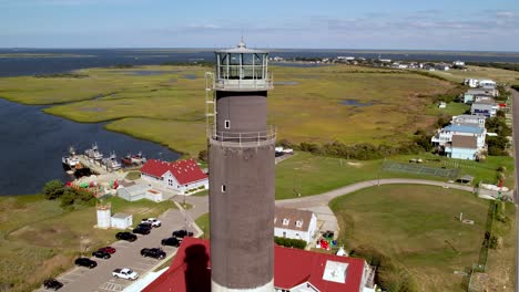 Oak-Island-Lighthouse-órbita-Aérea-En-La-Ciudad-De-Caswell-Beach-NC,-Carolina-Del-Norte
