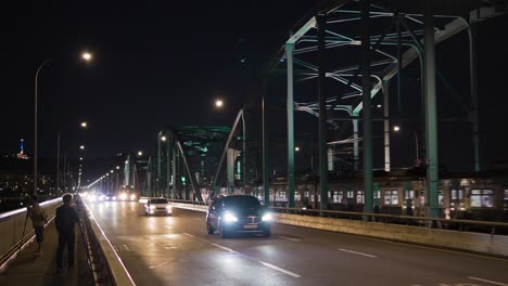 Dongjak-bridge-at-night---cars-traffic,-Seoul-metro-train-travel-on-bridge-railroad,-photographers-take-pictures-of-the-night-downtown-cityscape-and-Han-river