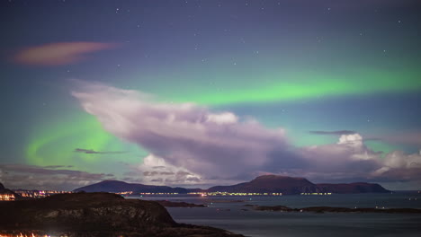 The-aurora-borealis,-stars-and-a-dynamic-cloudscape-over-Alesund,-Norway's-islands-and-sea-port---time-lapse