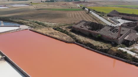 Aerial-view-of-salt-flats,-old-warehouses-and-surroundings
