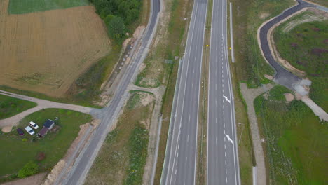 Aerial-view-flying-above-empty-transportation-motorway-lanes-in-quiet-countryside