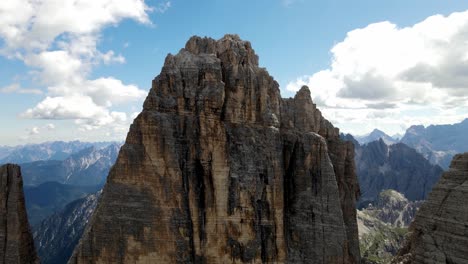 Aerial-views-of-The-Tre-Cime-di-Lavaredo-in-The-Italian-Dolomites-with-a-climber-on-the-summit