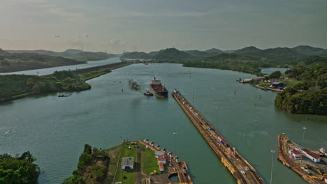 Panama-City-Aerial-v30-cinematic-drone-flyover-miraflores-locks-towards-pedro-miguel-locks-with-cargo-tanker-ship-transiting-at-the-canal-waterway---Shot-with-Mavic-3-Cine---March-2022