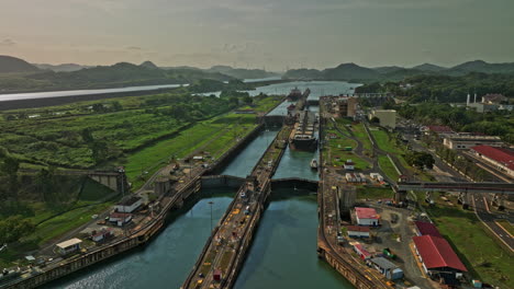 Panama-City-Aerial-v40-low-level-fly-around-miraflores-locks-capturing-hydraulic-structure-facility-with-cargo-ship-transiting-and-waiting-for-sluice-gate-to-open---Shot-with-Mavic-3-Cine---March-2022