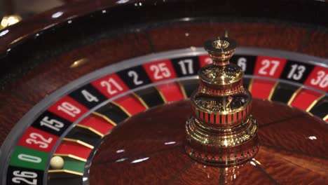 Roulette-wheel-in-casino-and-ball-on-zero-number,-lose-or-bad-luck-concept,-closeup-view