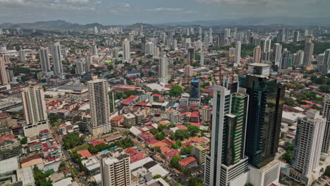 Panama-City-Aerial-v76-descending-flyover-capturing-downtown-cityscape-of-a-mix-of-high-rise-towers-and-low-rise-buildings-at-el-carmen-residential-neighborhood---Shot-with-Mavic-3-Cine---March-2022