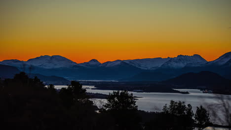 Golden-sunrise-over-the-mountains,-fjord,-and-islands-at-Alesund,-Norway---time-lapse