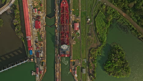 Panama-City-Aerial-v41-cinematic-vertical-top-down-view-flyover-miraflores-lake-towards-the-canal-locks-with-tanker-ships-transiting-at-the-facility---Shot-with-Mavic-3-Cine---March-2022