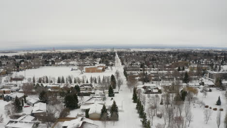 Drone-view-over-snow-covered-Dauphin,-Manitoba-during-wintertime