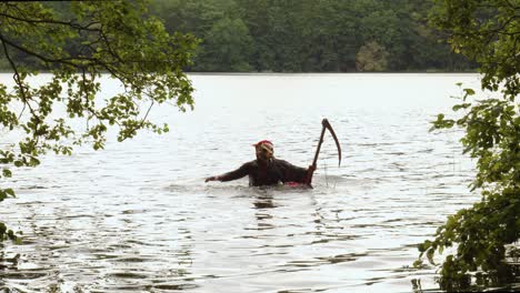 Grim-Reaper-With-Scythe-Emerge-From-The-Water-In-The-Lake