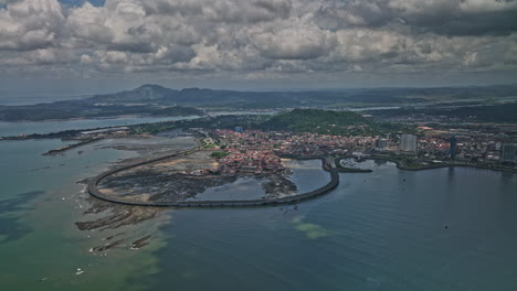 Panama-City-Aerial-v107-panning-view-capturing-beautiful-coastal-beltway-cinta-costera-3-bridge-and-townscape-of-historic-district-with-tropical-clouds-in-the-sky---Shot-with-Mavic-3-Cine---April-2022
