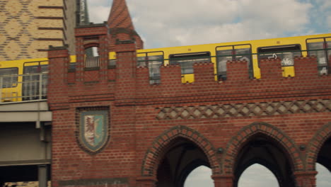 Tren-De-Metro-Urbano-U-bahn-Que-Pasa-Por-Un-Puente-De-Ladrillo-Rojo-En-Berlín,-Alemania