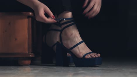 Close-up-of-young-woman-tying-her-high-heels-and-walking-away
