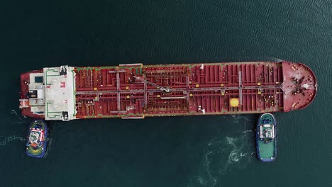 Tug-boats-assisting-a-tanker-in-distress-out-on-the-open-ocean---Cenital,-Aerial-view