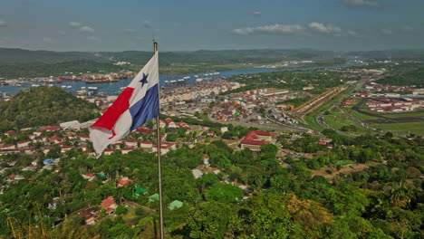 Panama-City-Aerial-v65-panoramic-view-fly-around-national-flag-on-ancon-hill-capturing-port-of-balboa-shipyard-canal,-historic-district-and-downtown-cityscape---Shot-with-Mavic-3-Cine---March-2022