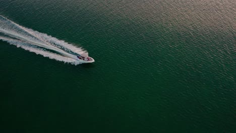 Slow-Motion-Aerial-Drone-Shot-Over-Speed-Boat-Passing-Through-Beautiful-Blue-Ocean-Tropical-Destination-Florida-Traveling-To-New-Destinations-Summer-Vacation-Concept-4k