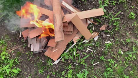 Slow-motion-of-burning-fire-on-the-wood-on-the-grass