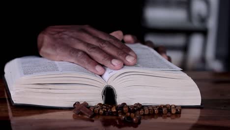 Praying-to-God-with-hand-on-bible-with-white-background-with-people-stock-footage-2