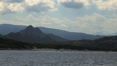 Remote-Saleccia-beach-of-Northern-Corsica-island-in-France-seen-from-boat-on-cloudy-day