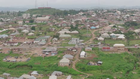 AERIAL---Cityscape-in-Jos-Plateau,-Nigeria,-truck-left-reveal