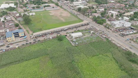 AERIAL---Cityscape-in-Jos-Plateau,-Nigeria,-tilt-up-reveal-wide-shot