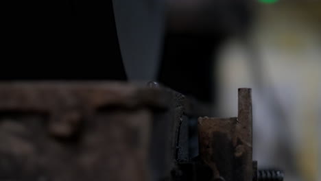 Closeup-shot-of-an-opening-rusty-steal-mold-discovering-and-lifting-a-heavy-plastic-object,-the-industrial-process-of-manufacturing-and-rotomolding-reuse-plastic