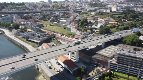 Aerial-view-of-a-highway-full-of-cars-in-a-bridge-above-the-river-of-Porto