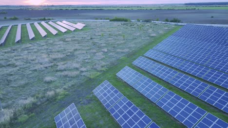 Aerial-tilt-up-over-solar-farm-in-Racari,-Romania---green-energy-production-from-photovoltaic-technology