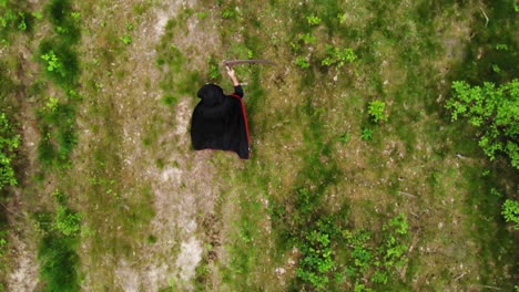 Top-View-Of-Death-Grim-Reaper-With-Scythe-Walking-In-Wilderness