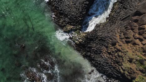 Aerial-view-of-Fingal-Heads-causeway-created-from-volcanic-pillar-rock-pushed-to-the-ocean-surface