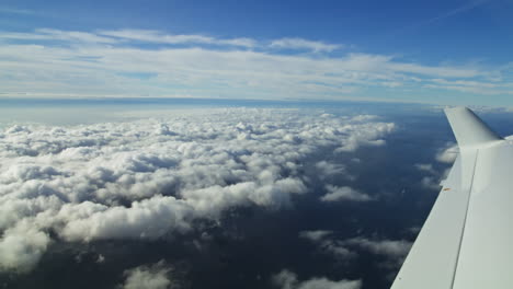 Hand-held-Shot-Of-A-Perspective-View-Out-Of-A-Window-Over-Looking-The-Wing-Of-An-Airplane