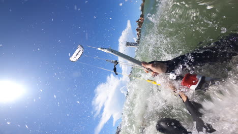 Professional-kite-surfer-performing-tricks-on-kiteboard-POV-vertical