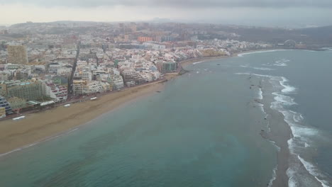Aerial-shot-at-dawn-and-forward-over-the-natural-barrier-of-Las-Canteras-beach-as-well-as-the-wonderful-beach