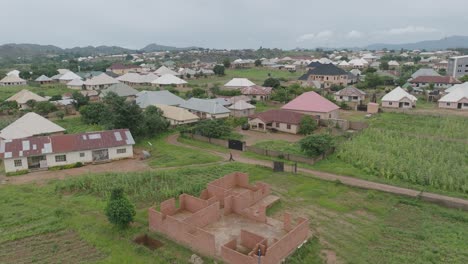 AERIAL---Cityscape-in-Jos-Plateau,-Nigeria,-forward-shot