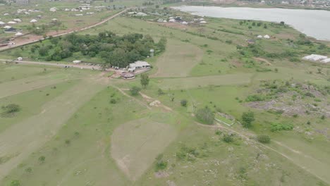 AERIAL---Lamingo-Dam-at-Jos-Plateau,-Nigeria,-forward-lowering-shot