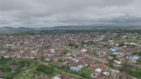 AERIAL---Cityscape-in-Jos-Plateau,-Nigeria,-spinning-shot