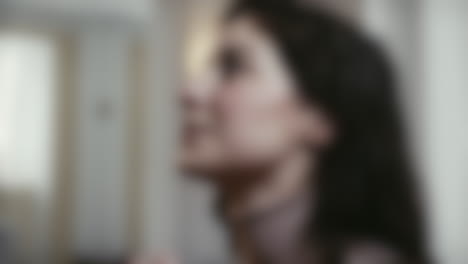 Blurred-close-up-shot-of-woman-praying-in-front-of-an-altar-with-folded-hands-in-a-catholic-church