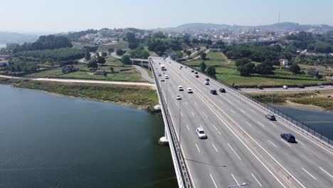Aerial-view-of-a-highway-full-of-cars-in-a-bridge-above-the-river-of-Porto-1