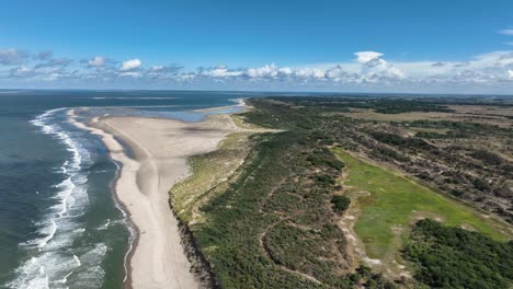 Beautiful-Aerial-Drone-Shot-Flying-Over-the-Dunes-of-Burgh-Haamstede-in-the-Netherlands-on-a-Summer-Day