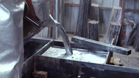 Still-Shot-with-a-slight-Pan-Down-of-Liquid-Metal-Pouring-in-the-Foundry