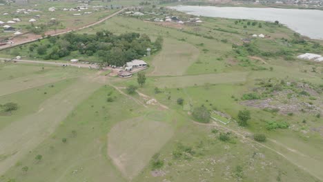 AERIAL---Lamingo-Dam-and-small-town,-Jos-Plateau,-Nigeria,-forward-shot