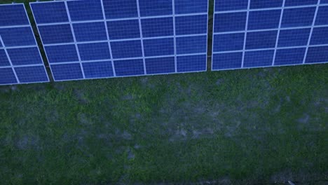 Drone-top-down-shot-over-rows-of-solar-panels-installed-on-solar-power-plant
