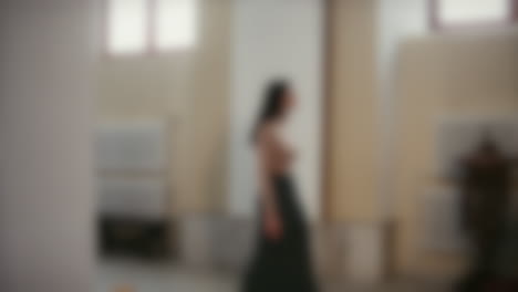 Blurred-shot-of-a-woman-walking-up-to-the-altar-to-pray-in-a-catholic-church