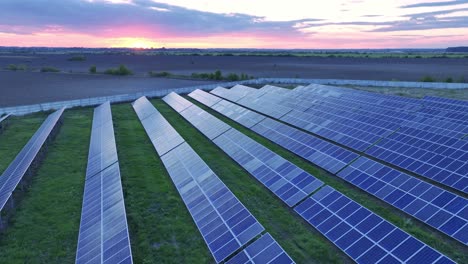 Big-solar-power-system-installation-in-countryside-of-Racari,-Romania---sunset-aerial-tilt-up-shot-in-countryside