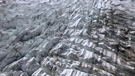 Drone-shot-starting-downward-and-tilting-up-to-reveal-glacier-at-Fairy-Meadows-Pakistan,-cinematic-aerial-shot