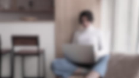 Blurred-shot-of-woman-with-her-laptop-in-her-lap-looking-for-jobs-online-and-writing-application-letters
