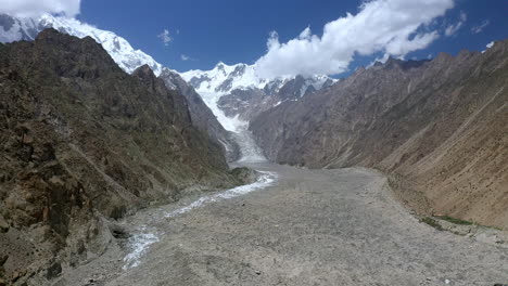 Wide-drone-shot-of-Passu-Cones-Pakistan-with-the-glacier-path,-cinematic-wide-aerial-shot