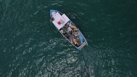 Drone-circling-the-Fishing-boat-attached-with-a-skiff-from-top-in-the-sea-adjoining-the-Haifa-beach-around-Hof-Hacarmel