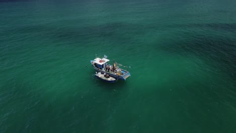 Drone-tracking-fishing-boats-in-the-turquoise-colored-Haifa-bay-at-Hof-Hacarmel-in-Israel