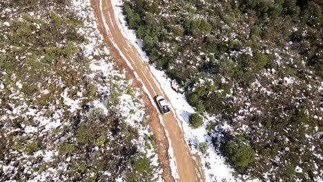 Aerial-follow-of-car-riding-through-the-dirt-road-in-Oncol-Park,-Chile